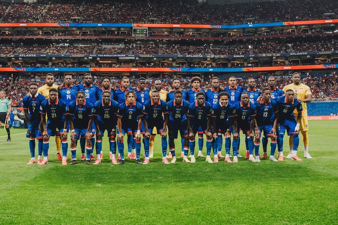 Haiti national football team lined up in a stadium before a match.